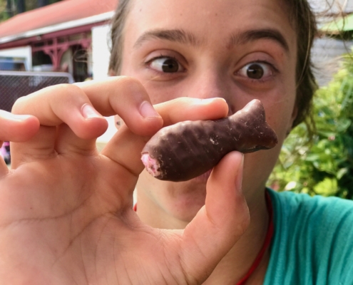 Girl with chocolate fish in New Zealand