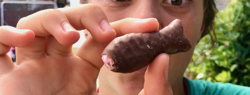 Girl with chocolate fish in New Zealand