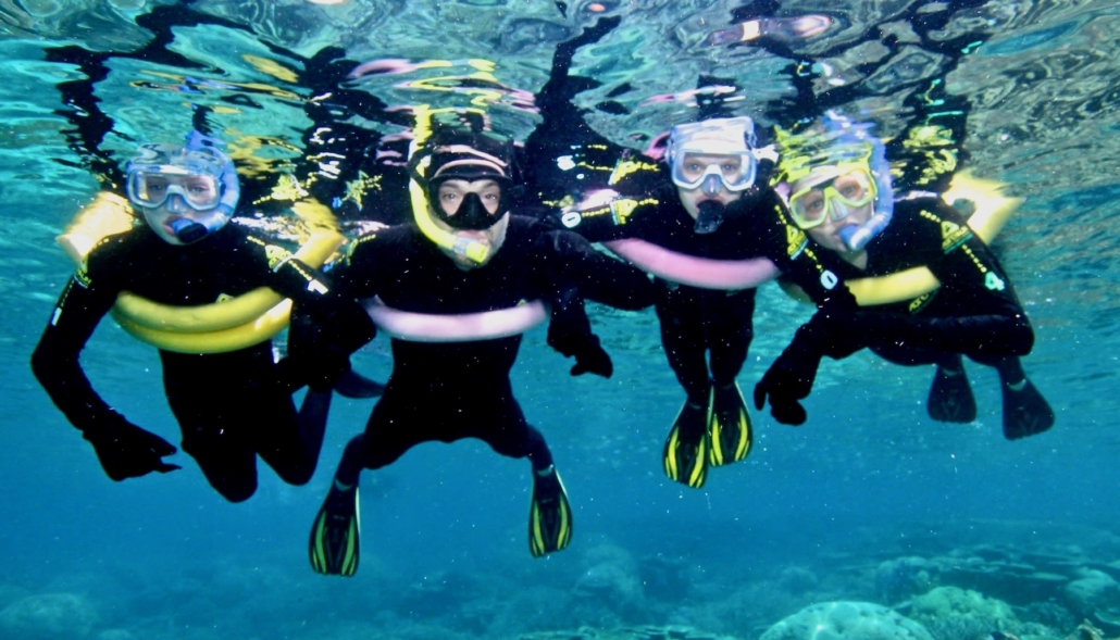 family snorkeling in Belize