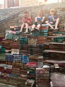 Venice bookstore, kids sitting on a stack of books