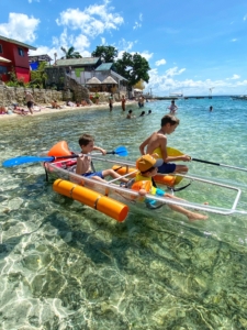 kids playing in the Philippines with a makeshift boat