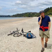 Man on beach doing a work call