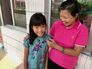 a returned resident of Chinese orphanage with her caregiver