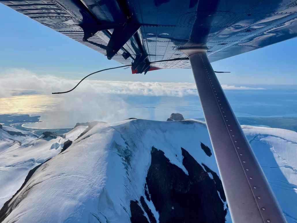 wing of a plane over Alaska; worldschooling