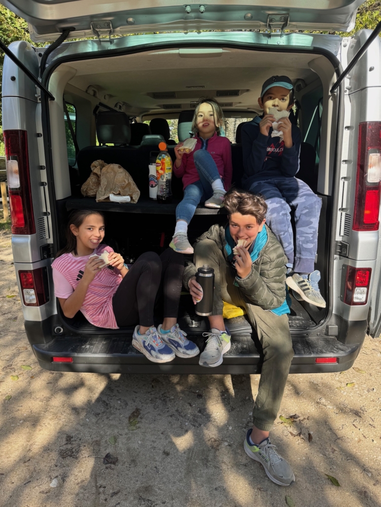 four worldschooling kids in the back of a van